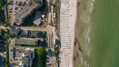 Aerial-birds-eye-overhead-top-down-view-of-tourist-beach-in-Scharbeutz,-Germany,-Baltic-sea,-forward,-day
